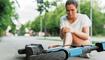 Young woman suffering from knee pain after e-scooter riding accident