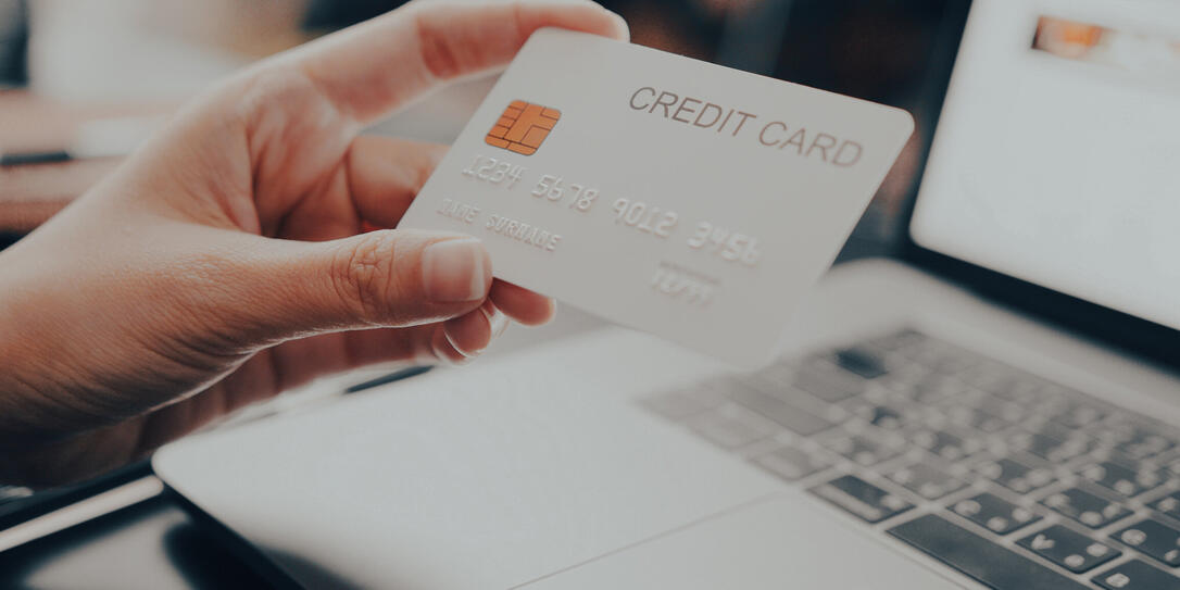 Close-up Attractive woman holding credit card Making Online Payment while online shopping on laptop computer