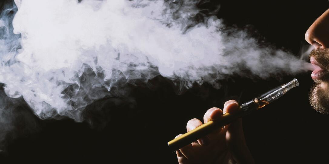 vaping man isolated on a black background. vaping man isolated on a black background.