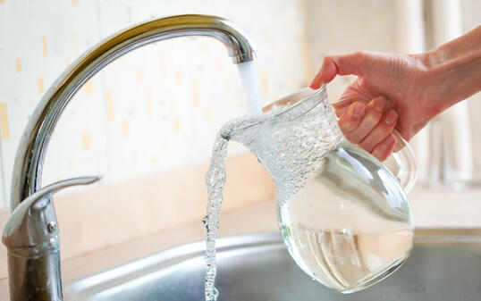 Filling glass pitcher with water