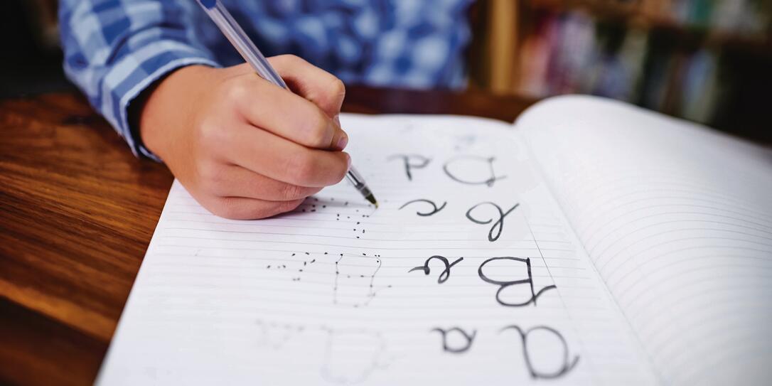 Practising his handwriting