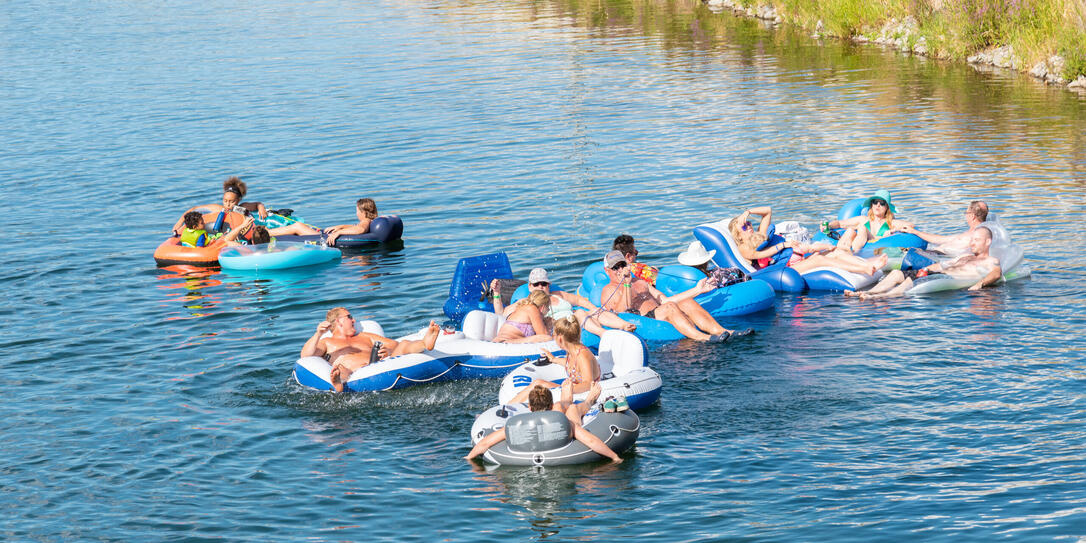 Large group of people floating down the Penticton River Channel in summer Large group of people floating down the Penticton River Channel in summer