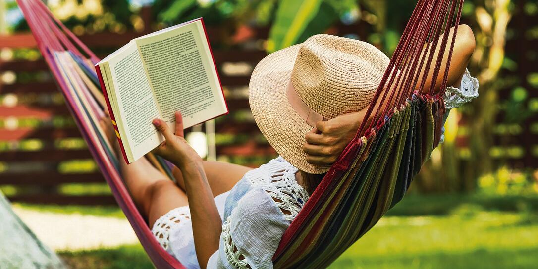 Woman reading book in hammock