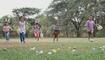 Happy group of diverse cute little children hunting Easter eggs, wearing bunny ears. kids holding basket, running to collect eggs on grass while playing outdoors at park