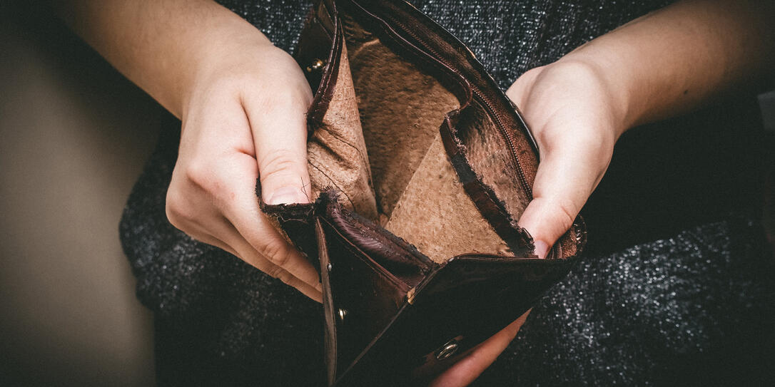 Old empty wallet in the hands .Vintage empty purse in hands of women . Poverty concept, Retirement. Special toning