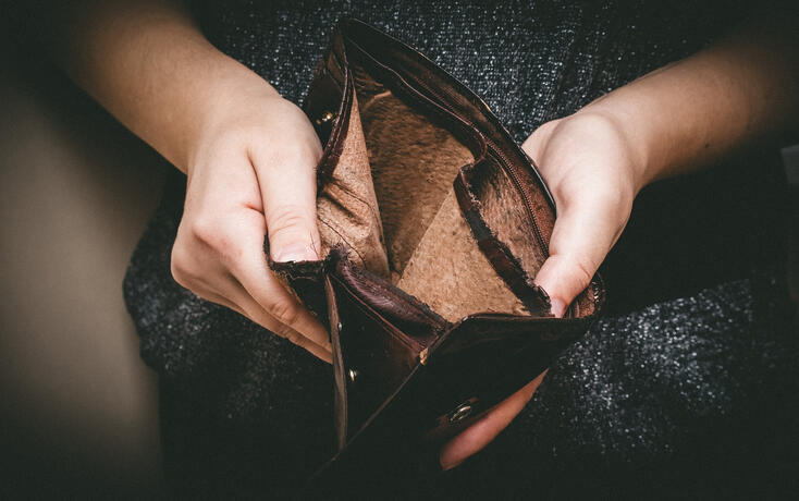 Old empty wallet in the hands .Vintage empty purse in hands of women . Poverty concept, Retirement. Special toning