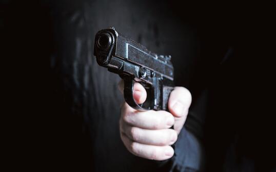 gun in the hand of man