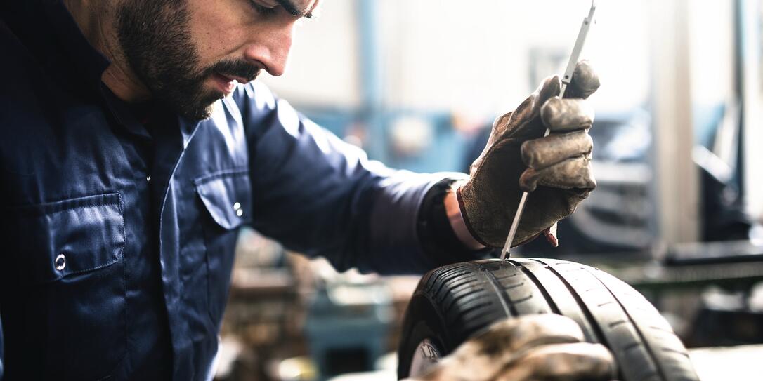 tire repairer checking the tire integrity