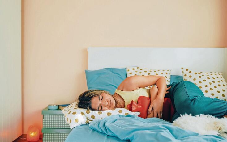 Woman with stomach pain staying home