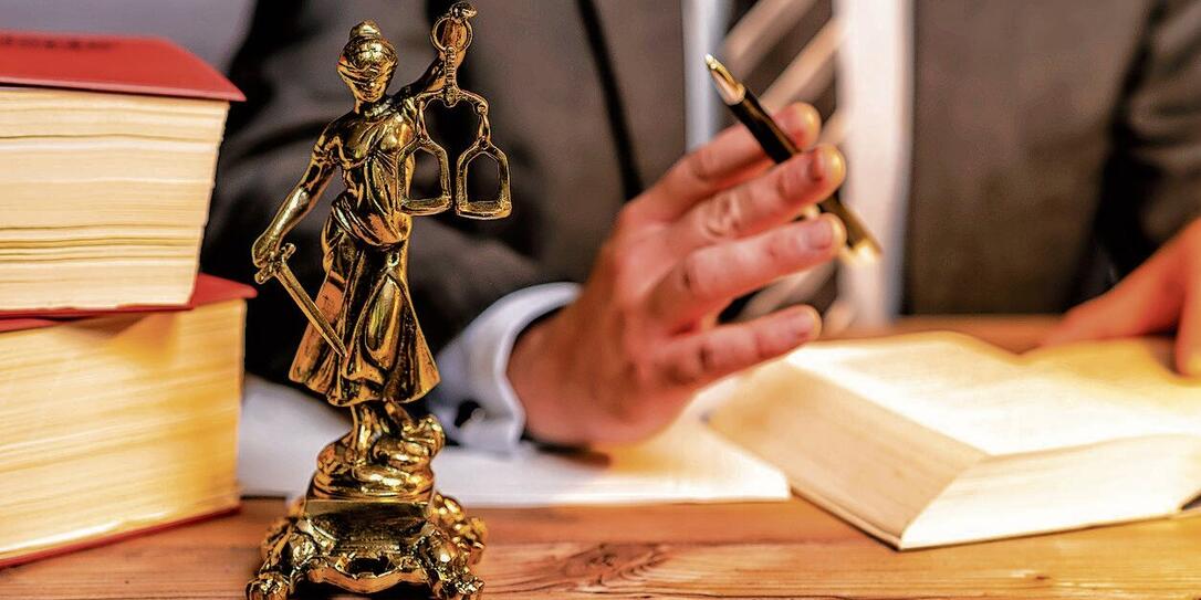 office of a lawyer with statue of Lady Justice, goddess Justitia, on the desk