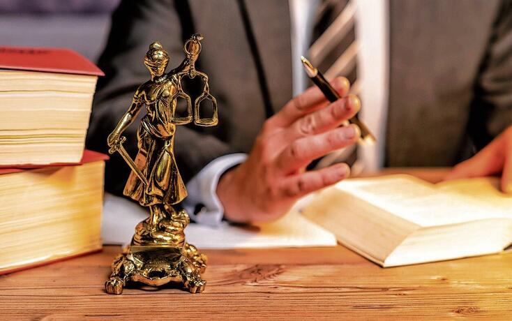 office of a lawyer with statue of Lady Justice, goddess Justitia, on the desk
