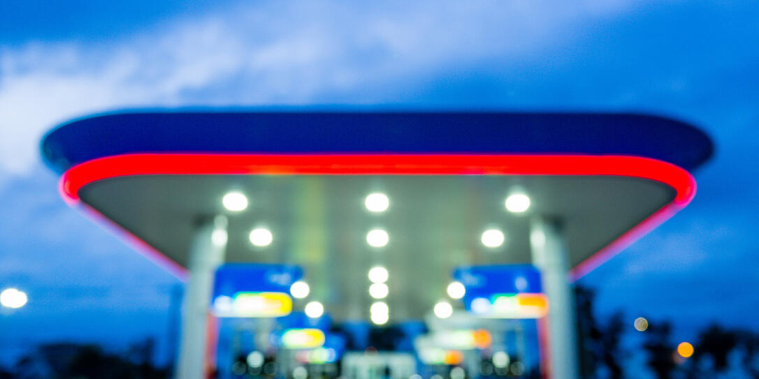 Blur image of twilight gas station during sunset.