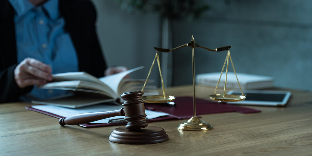 Lawyer office. Statue of Justice with scales and lawyer working on papers, Advice and justice concept. Lawyer office. Statue of Justice with scales and lawyer working on papers, Advice and justice concept.
