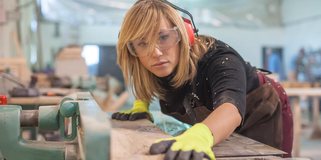 Female carpenter Using Electric Sander