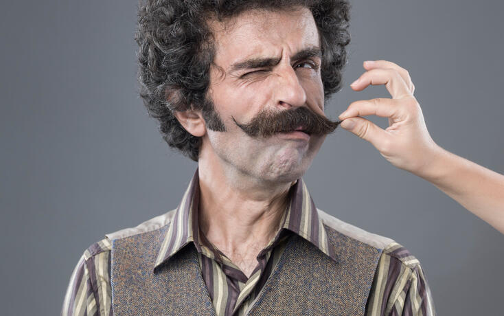 Woman Hand Pulling Up Adult Man's Handlebar Moustache