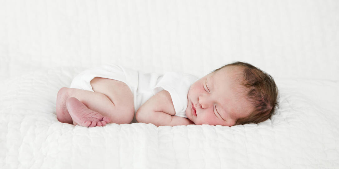 Newborn Baby Sleeping Wearing White