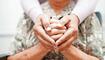 Caregiver holding hands Asian elderly woman patient, help and care in hospital.