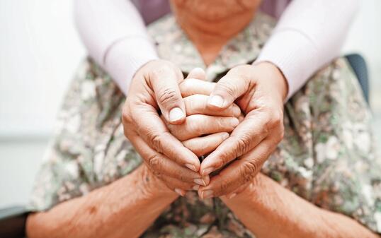 Caregiver holding hands Asian elderly woman patient, help and care in hospital.