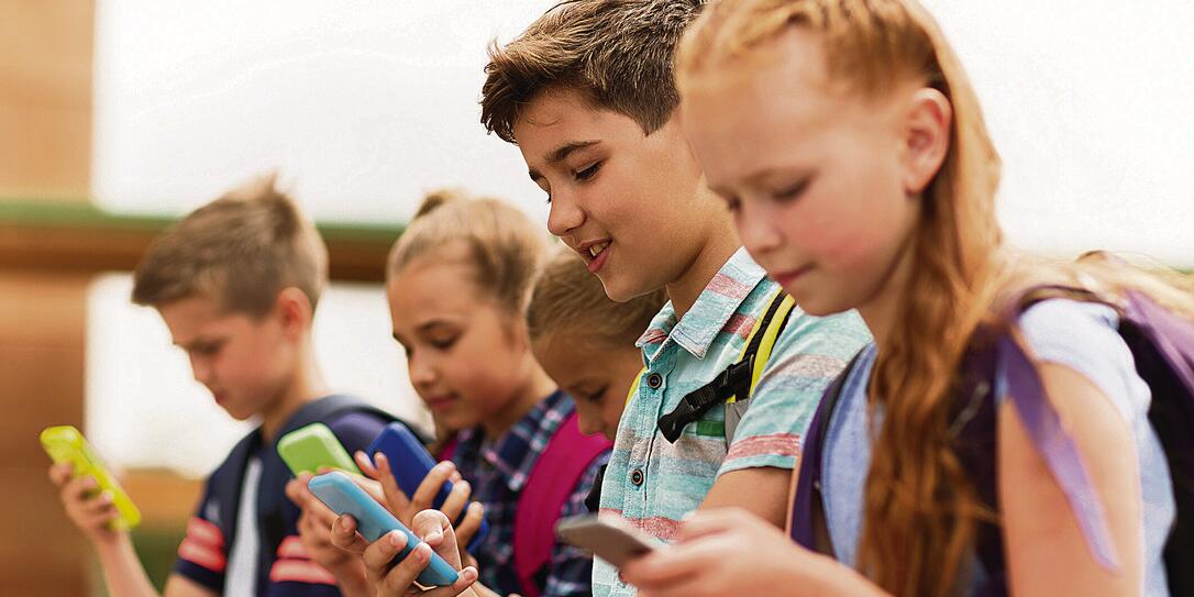elementary school students with smartphones elementary school students with smartphones