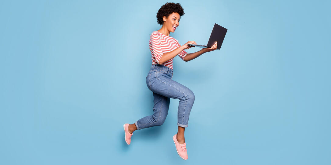 Full length body size side profile photo of pretty cheerful cute nice charming youngster typing before laptop wearing jeans denim striped shirt isolated pastel color blue background