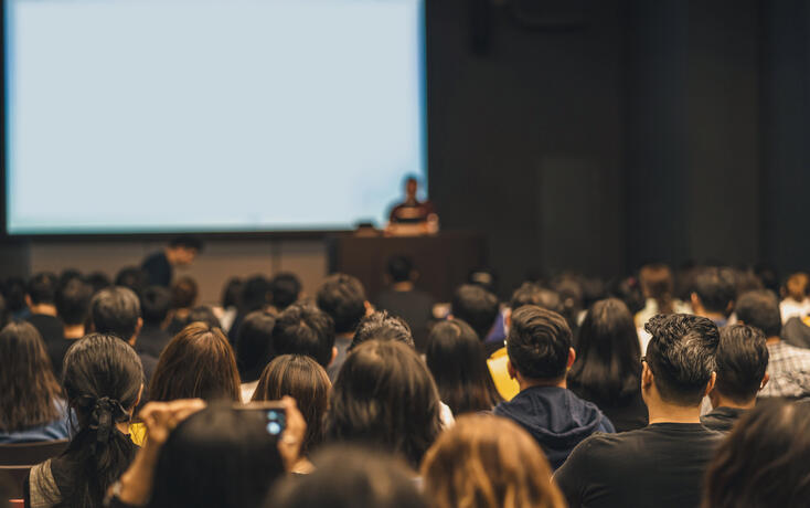 People Attending Seminar In Convention Center