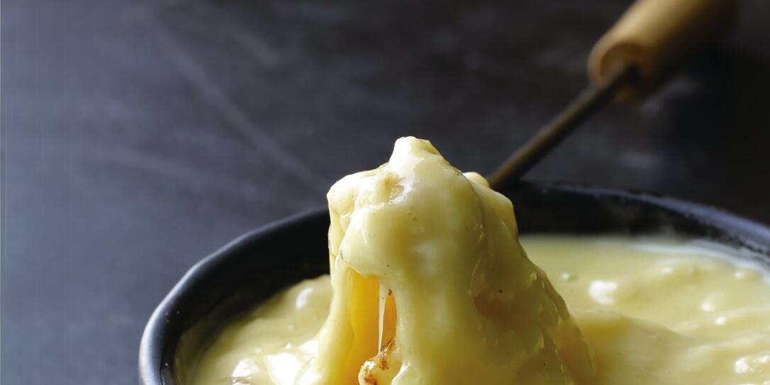 fondue - a piece of bread (croutons) in liquid cheese