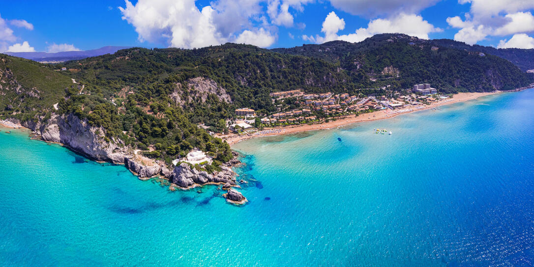 Greece summer holidays. Best scenic beaches of Corfu island - aerial panoramic view of Glyfada beach and village in western part