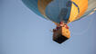 Family In Hot Air Balloon Against Clear Sky