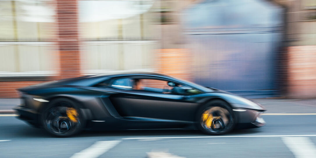 Black Lamborghini sports car in motion