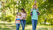 Family of four walking through the park