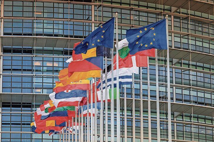 Set of European flags in front of the European Parliament