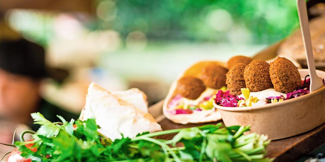 Fresh falafel and salad on display at vegan vegetarian stall at food market Fresh falafel and salad on display at vegan vegetarian stall at food market