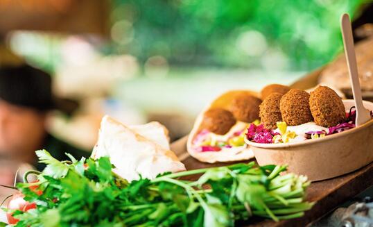 Fresh falafel and salad on display at vegan vegetarian stall at food market