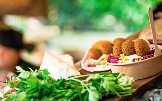 Fresh falafel and salad on display at vegan vegetarian stall at food market