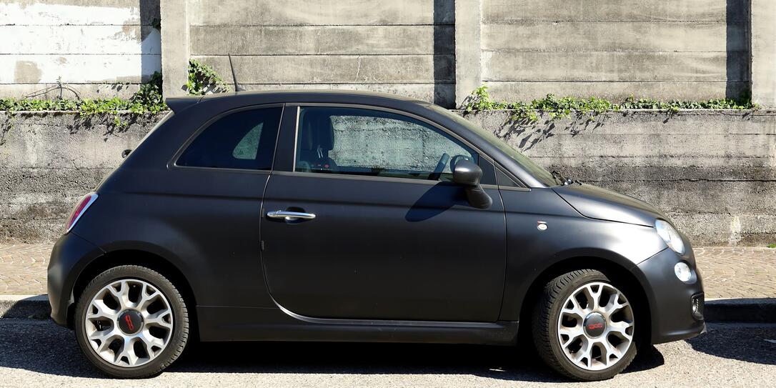 Side view of matt black new Fiat 500. Side view of matt black new Fiat 500.