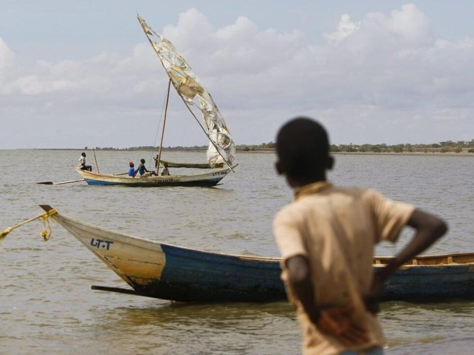 Ein Junge wartet auf die Rückkehr eines Fischerbootes auf dem Turkanasee in Kenia. Die Nationalparks am See wurden auf die Liste des gefährdeten Welterbes der Unesco aufgenommen. (Archivbild)