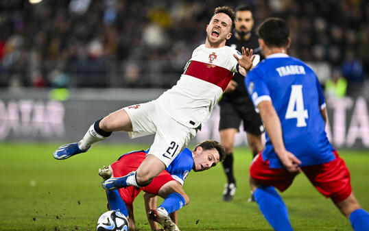 Simon Lüchinger (unten) im Zweikampf mit Diogo Jota (weiss) am 16. November 2023 im Rahmen der Qualifikation zur Europameisterschaft 2024 in Vaduz.