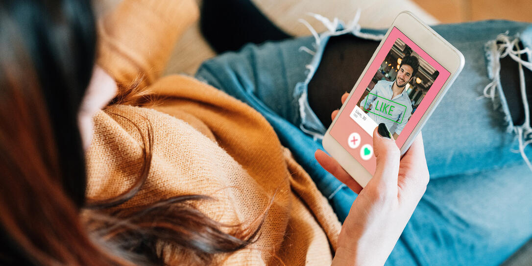 Young adult woman swiping on an online dating app Young adult woman swiping on an online dating app