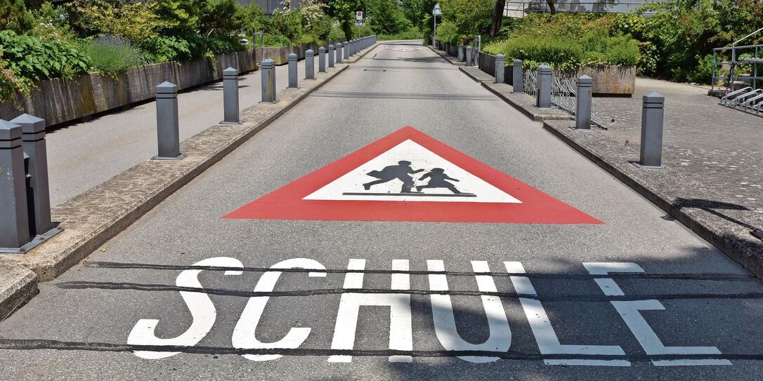 Warning sign of the way to school in German language  in Switzerland.