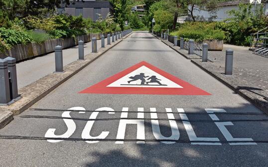 Warning sign of the way to school in German language  in Switzerland.