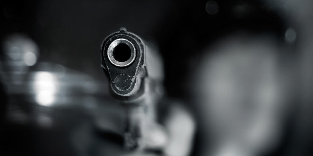 Black and white, woman pointing old gun to front Black and white, woman pointing old gun to front