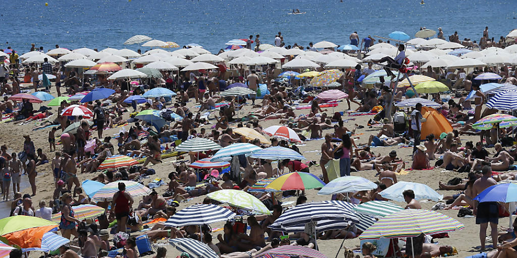 Grossandrang an spanischen Stränden: Touristen liegen in Barcelona an der Sonne.