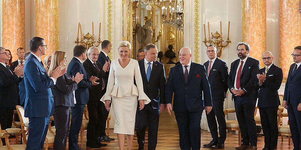 Andrzej Duda (M,r), Präsident von Polen, und seine Frau Agata Kornhauser-Duda (M,l), im Königlichen Schloss bei der Übergabezeremonie nach der Präsidentenwahl. Foto: Hubert Mathis/ZUMA Wire/dpa