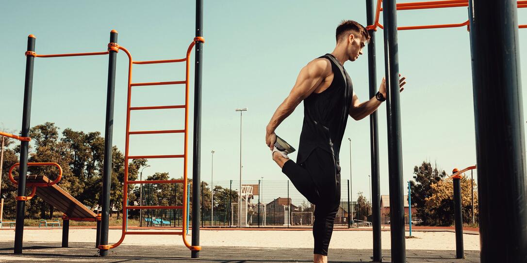 athletic guy warms up before classes on the horizontal bar