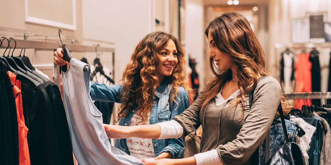 Two friends shopping for clothes