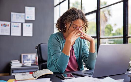 Stressed multiethnic businesswoman at work