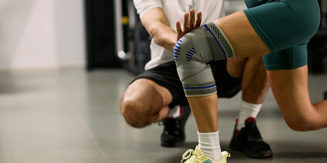 Caucasian Young Woman Performing Knee Rehabilitation Exercise with Therapist