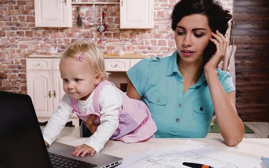 business woman working her baby girl