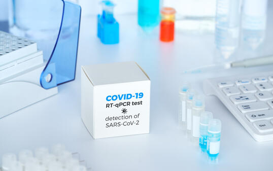 Quick novel COVID-19 coronavirus test kit. 2019 nCoV pcr diagnostics kit. Hand in glove with the box. The kit detects covid19 virus. Ð¢est system for real-time quantitative PCR amplification.