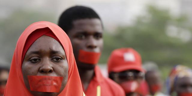 People march during a silent protest calling on the government to rescue the kidnapped girls of the government secondary school in Chibok, who were abducted a year ago, in Abuja, Nigeria, Monday, April 13, 2015. Nearly 300 schoolgirls from Chibok were abducted in a mass kidnapping on the night of April 14-15. Dozens escaped on their own but 219 remain missing. (AP Photo/Sunday Alamba)